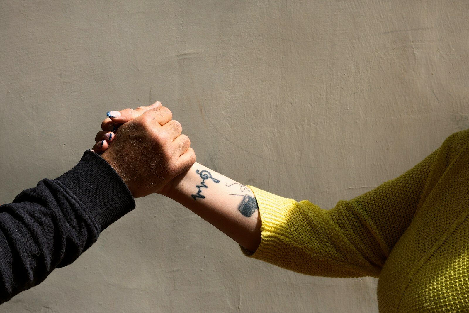 a person's hands with tattoos